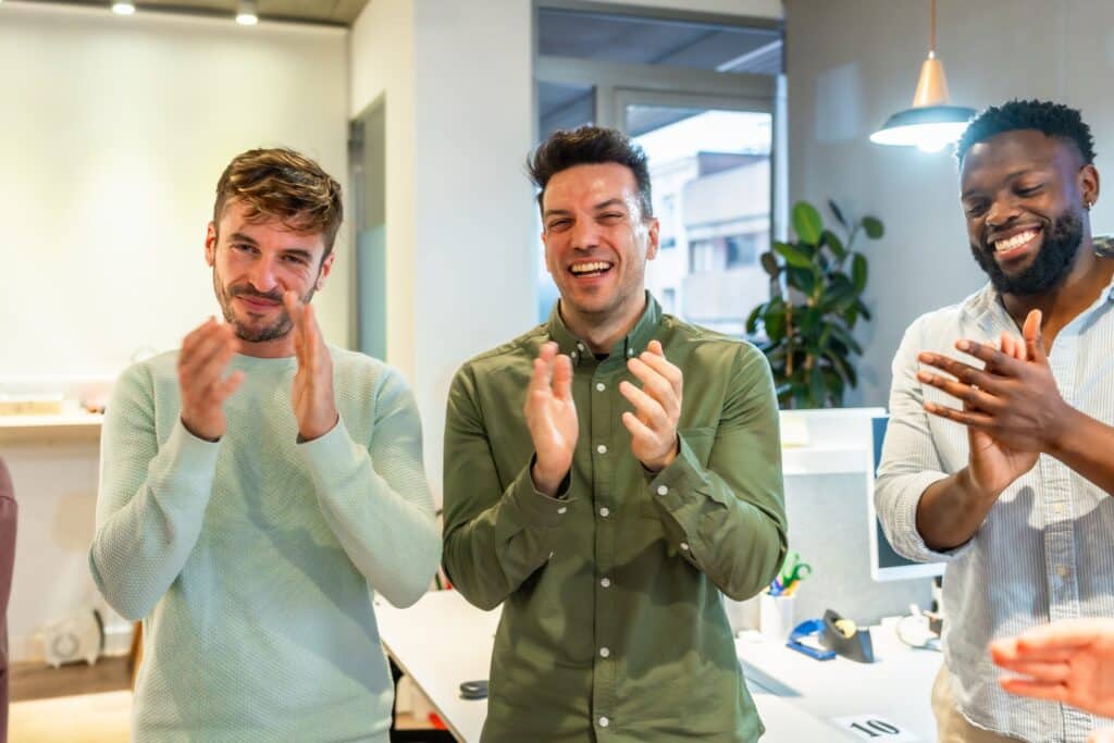 A group of happy office workers high fiving
