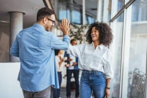 Two happy business people high five