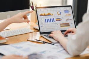 Two Businesspeople Analyzing Data Charts