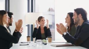 Business people applaud in a meeting