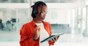 woman with an ipad speaking over headset