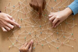 Hands connecting pins and small ropes