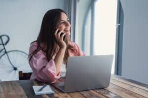 woman smiling with phone over ear