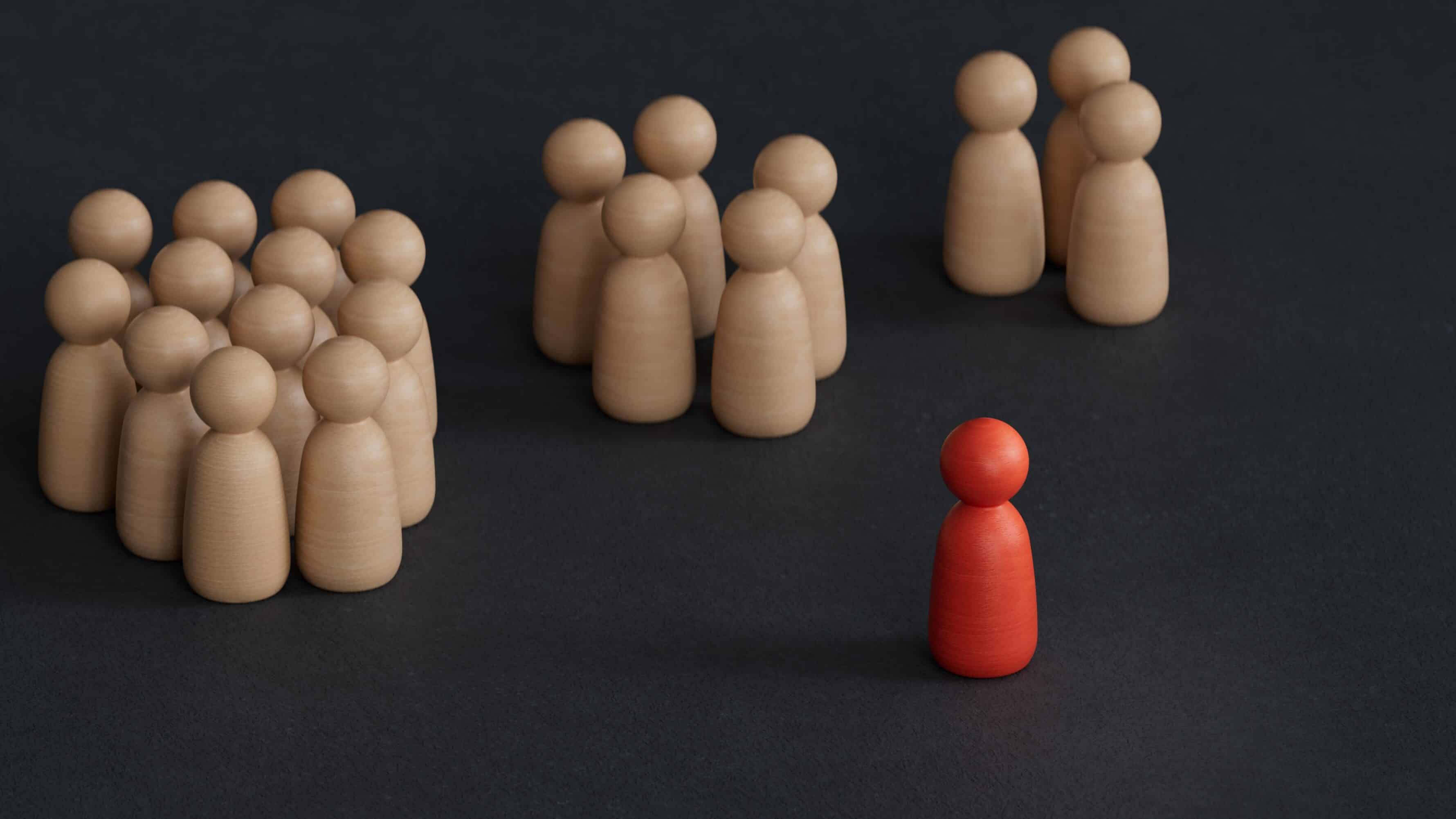 Groups of wooden figures and one in front