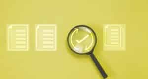 Magnifying glass with checklist documents