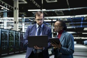 Two people looking at laptop and discussing